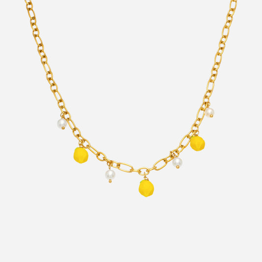 Gold chain necklace with yellow and white bead accents on a white background
