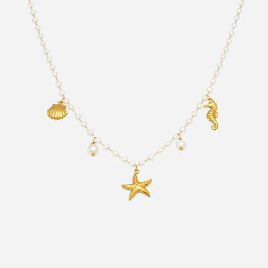 Necklace with gold seahorse, shell, and starfish charms on a white background