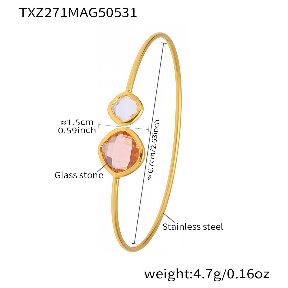 Gold bracelet with glass stones and measurements on a white background