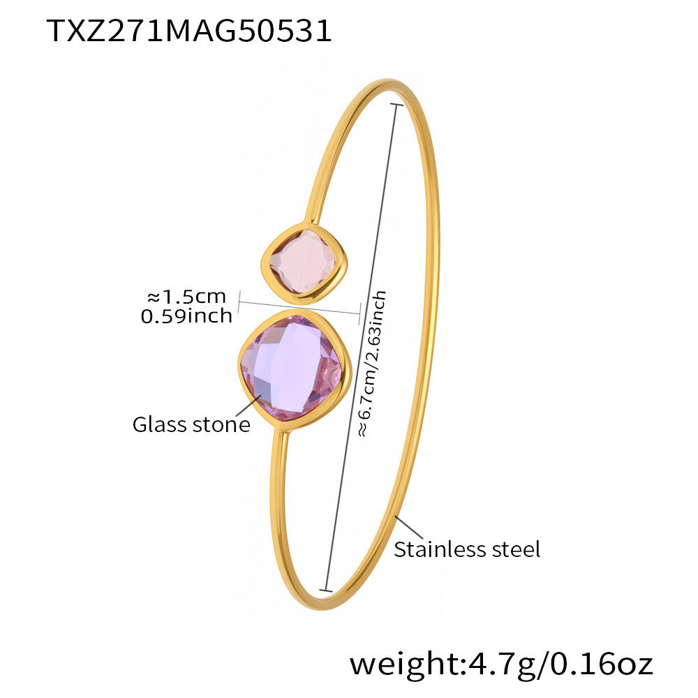 Gold bracelet with pink glass stones and measurements on a white background