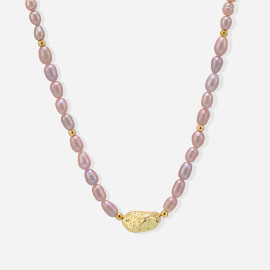 Minimalist gold freshwater pearl necklace displayed on white background
