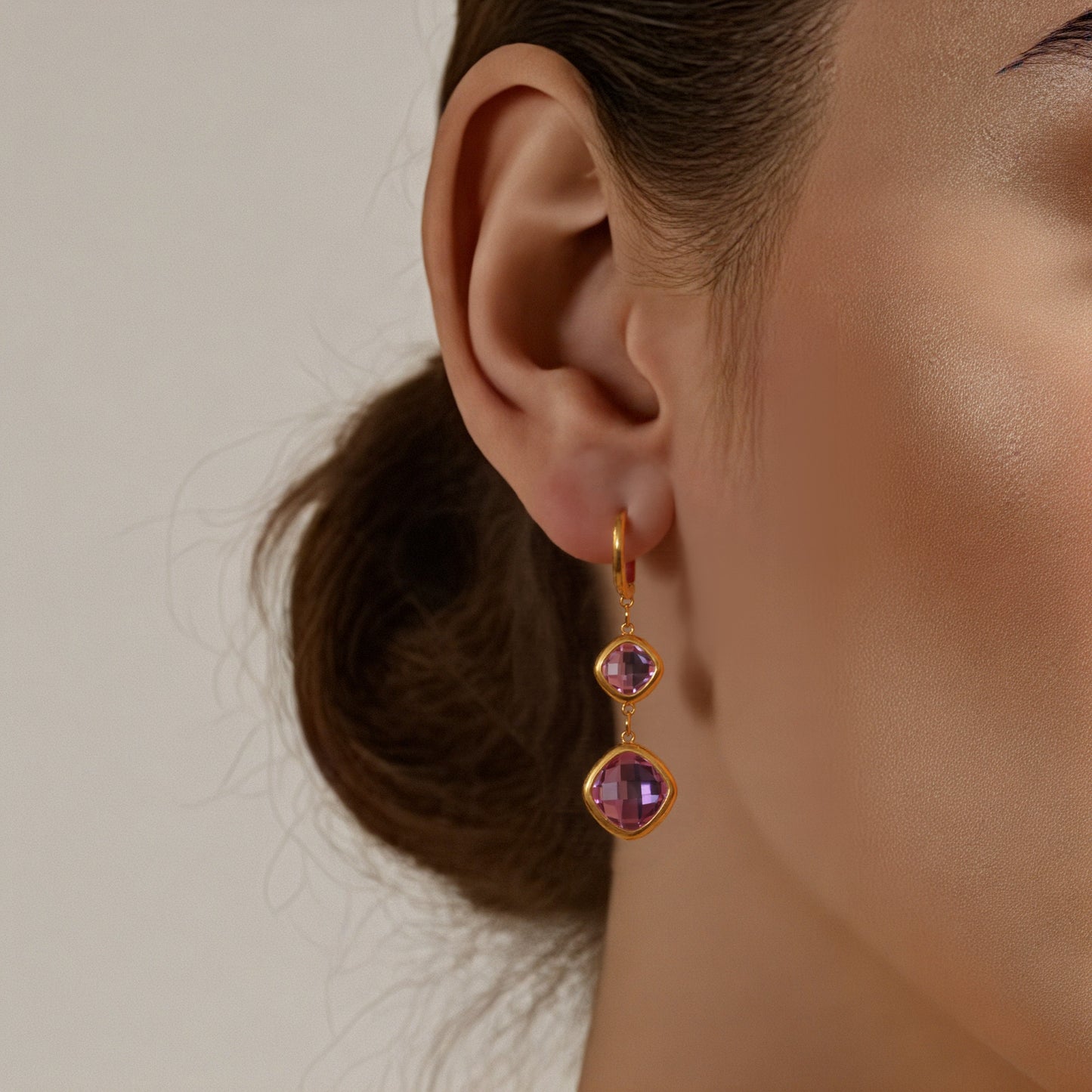 Model wearing purple gemstone drop earrings in gold, lightweight stainless steel earrings