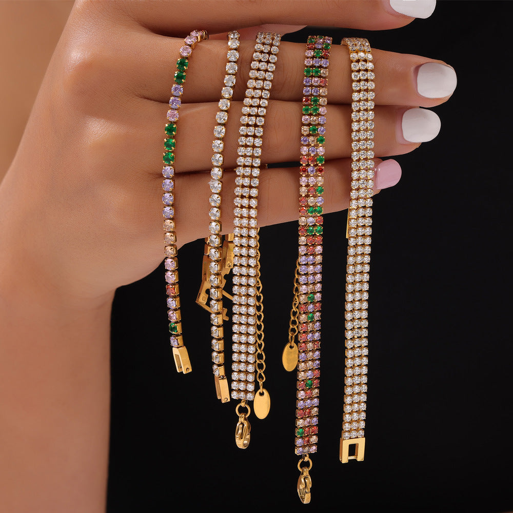 Hand holding rainbow zircon beaded bracelets on a black backdrop – colorful stainless steel jewelry