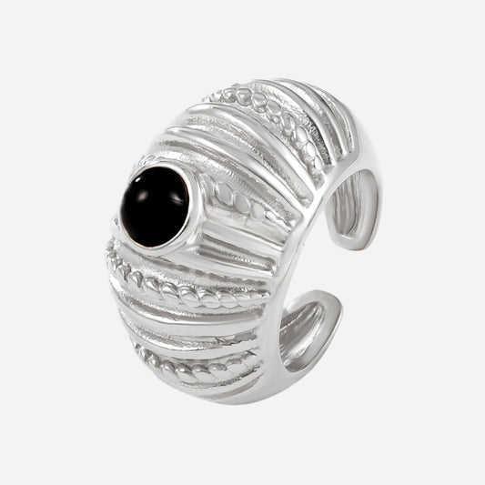 Silver ring with a black gemstone on a white background