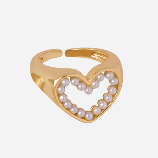 Gold heart-shaped ring with pearls on a white background