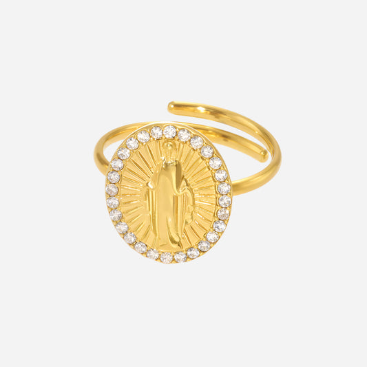 Gold ring with a religious design on a white background