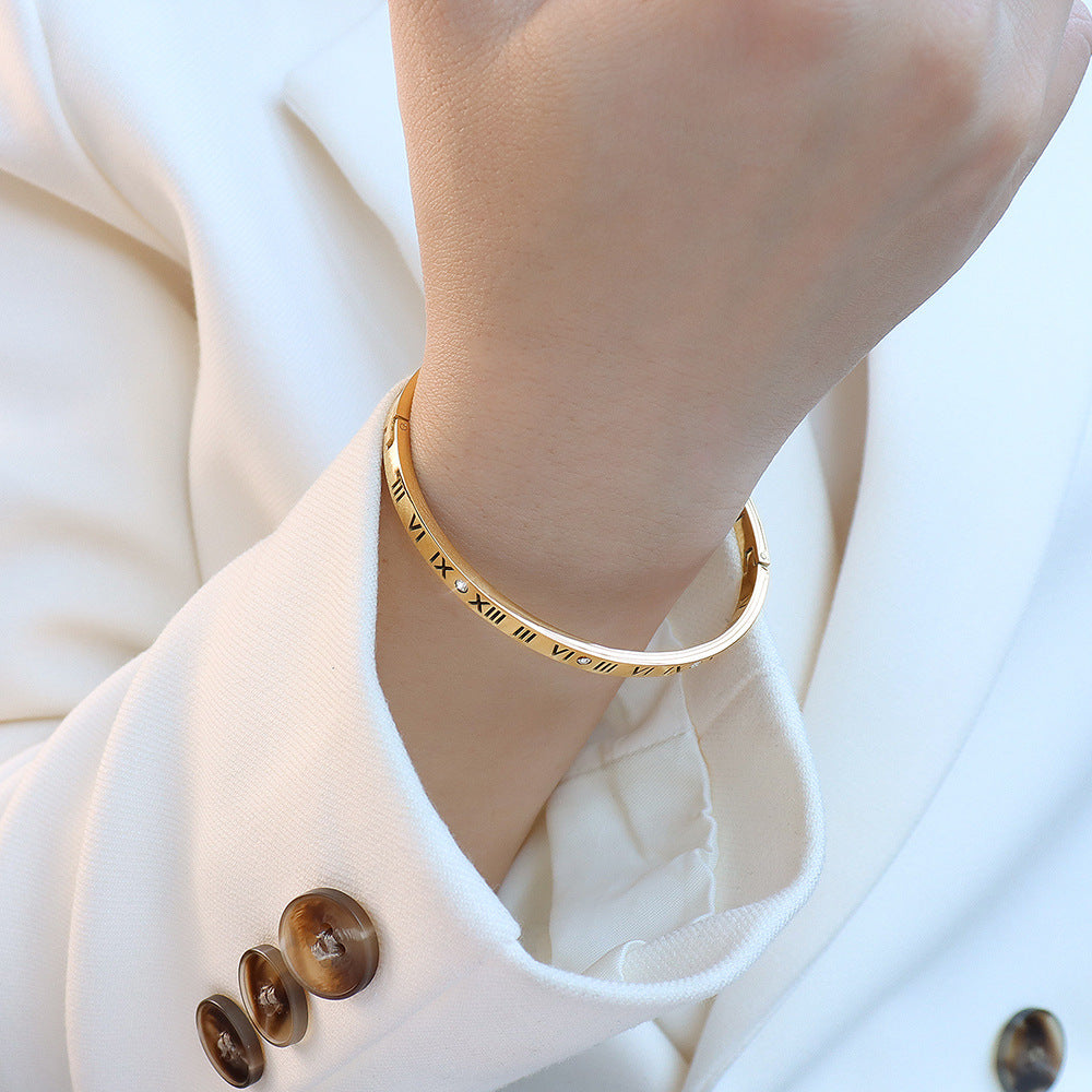 Gold Roman numeral bracelet worn on wrist, crafted from 304L stainless steel