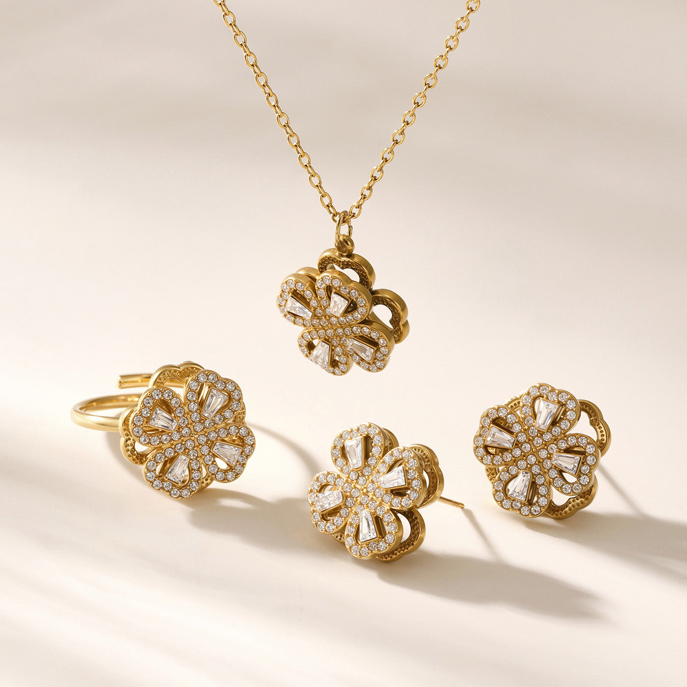 Gold rotating flower cubic zirconia necklace and ring placed in elegant lifestyle scene