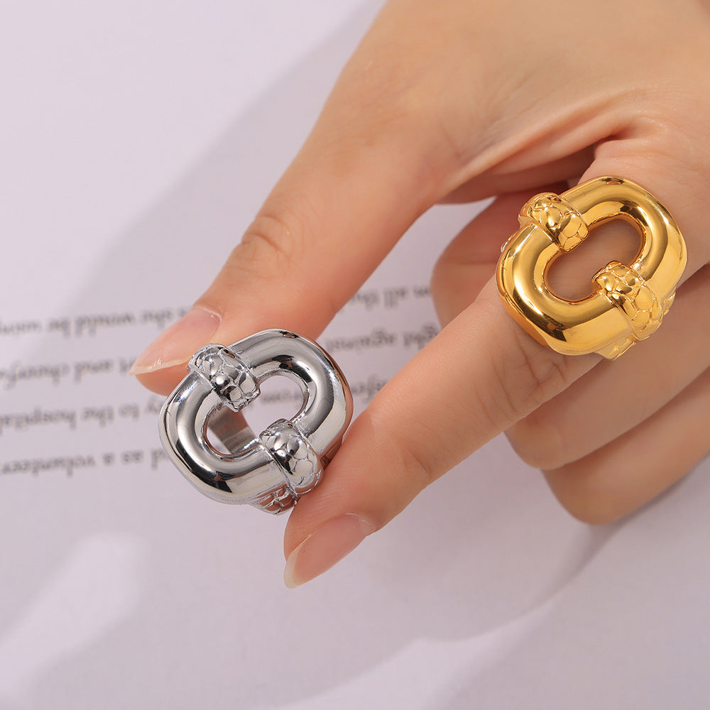 Hand wearing adjustable gold and silver rings with intricate designs on white background – stacked jewelry