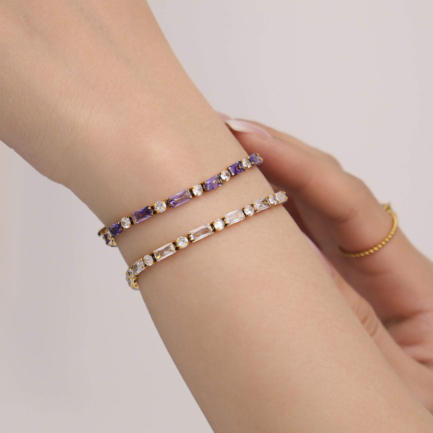 Minimalist gold and beaded bracelets stacked on wrist – stainless steel with gemstones