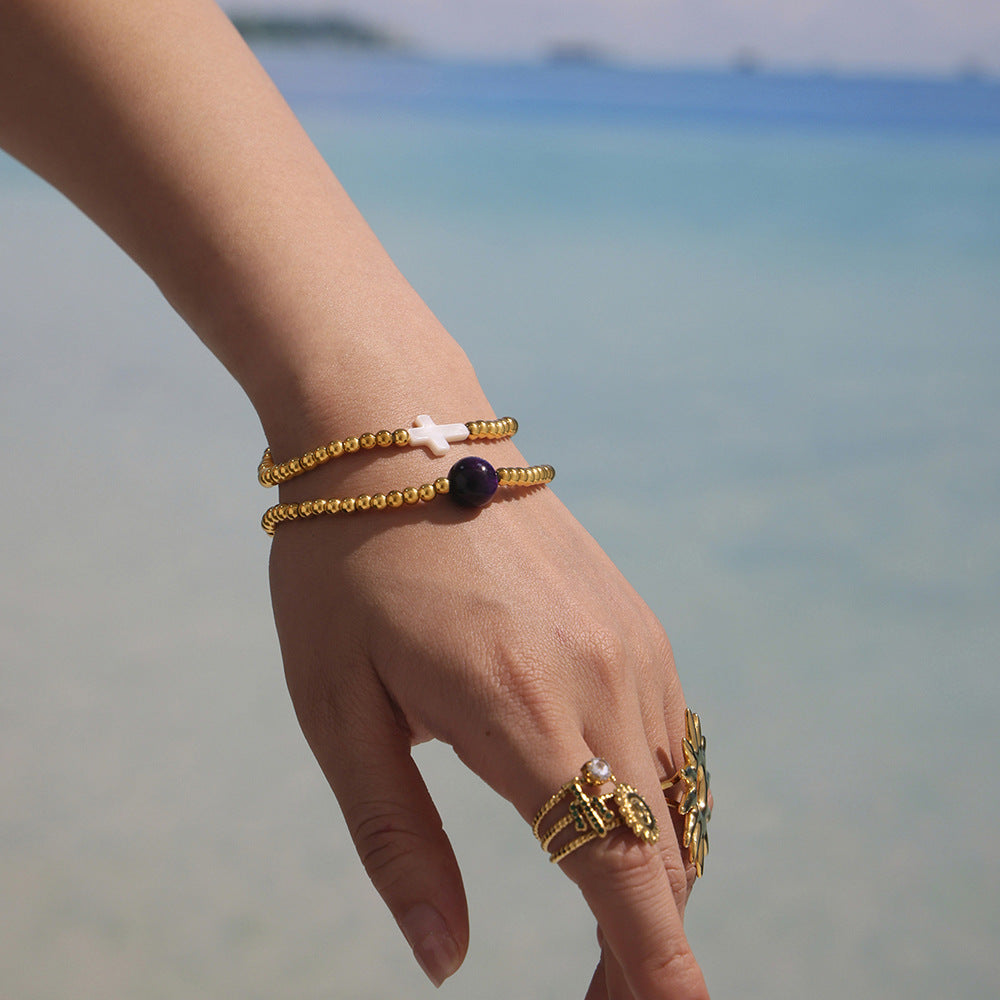 Model Wearing Dual Cross Charm Beaded Bracelets – White Shell and Agate in Gold