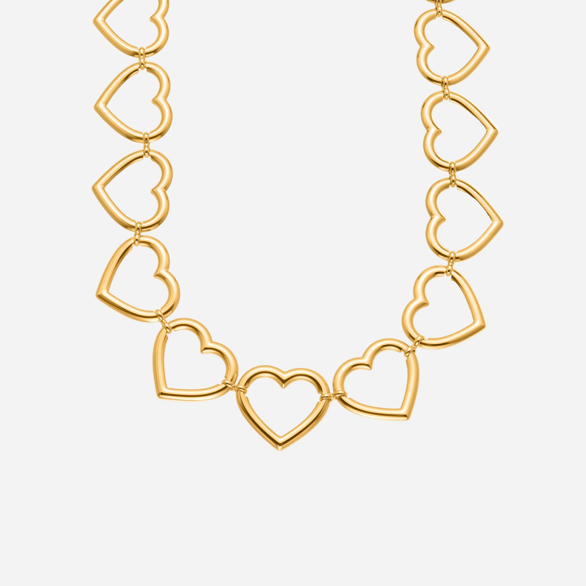 Gold heart chain necklace with big linked hearts on a white background