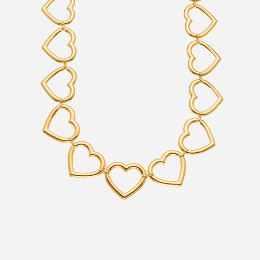 Gold heart chain necklace with big linked hearts on a white background