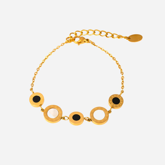 Gold tennis bracelet with circular links on a white background