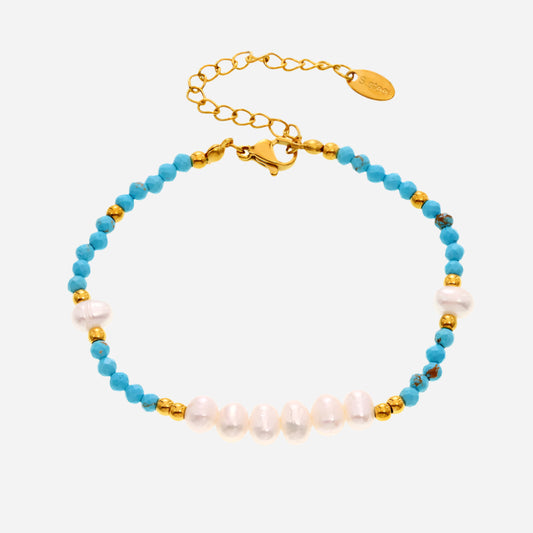 White background view of handmade turquoise and freshwater pearl beaded bracelet