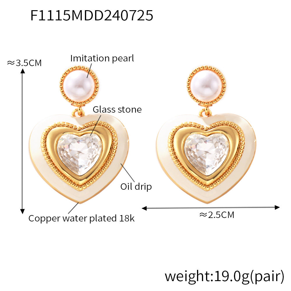 Size chart of gold heart stud earrings with white gemstone center and pearl top, showing dimensions and product details