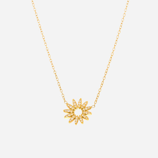 Gold sunflower charm necklace with white cubic zirconia on white background