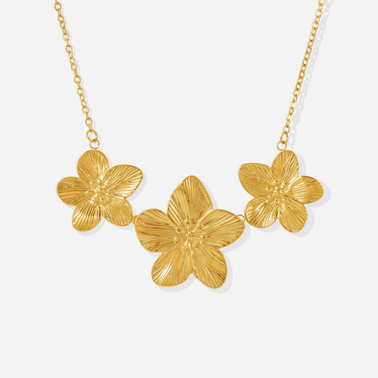 Dainty floral charm tennis necklace on white background