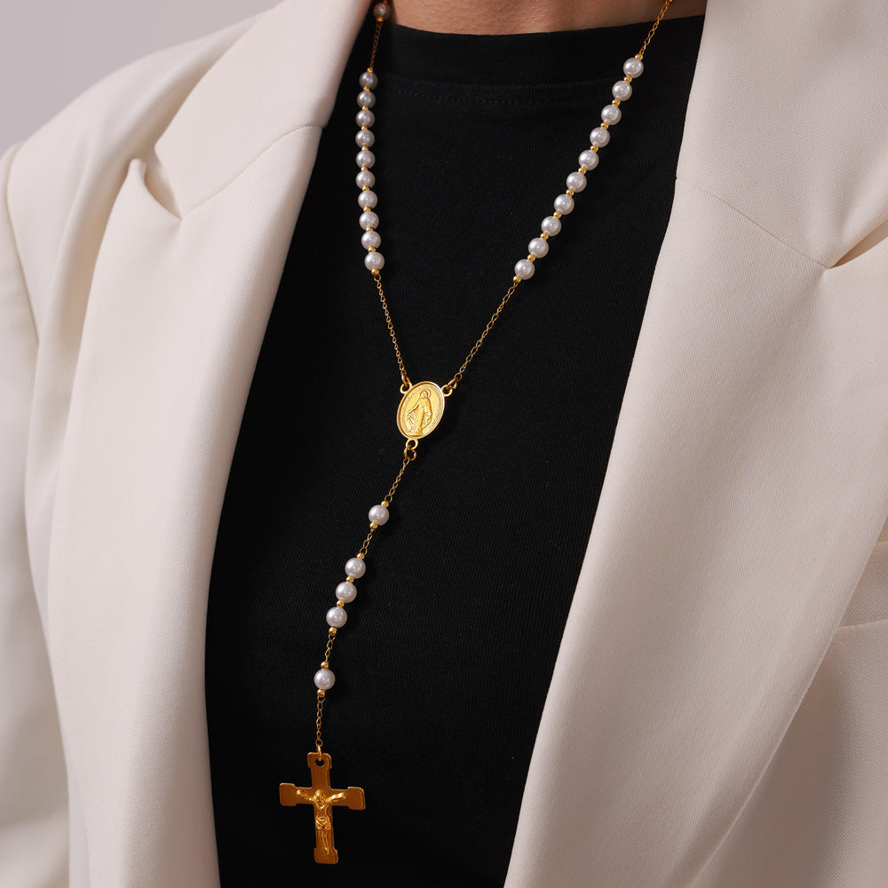 Elegant Gold Tassel Cross Pendant Necklace Styled with Classic White and Black Outfit