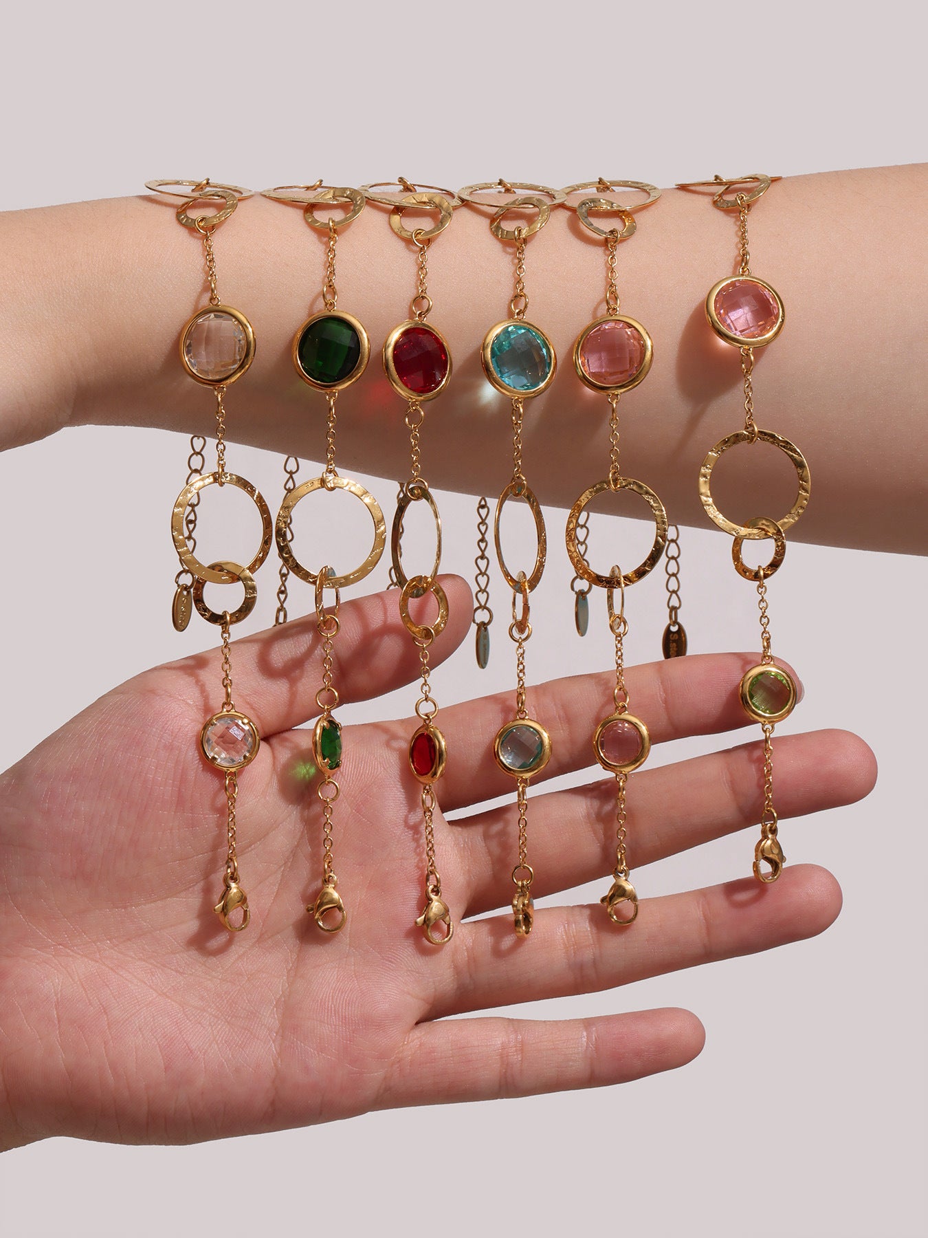 Model Wearing Multiple TXE281 Bracelets in Pink, Red, and Multicolor – Stacked Style