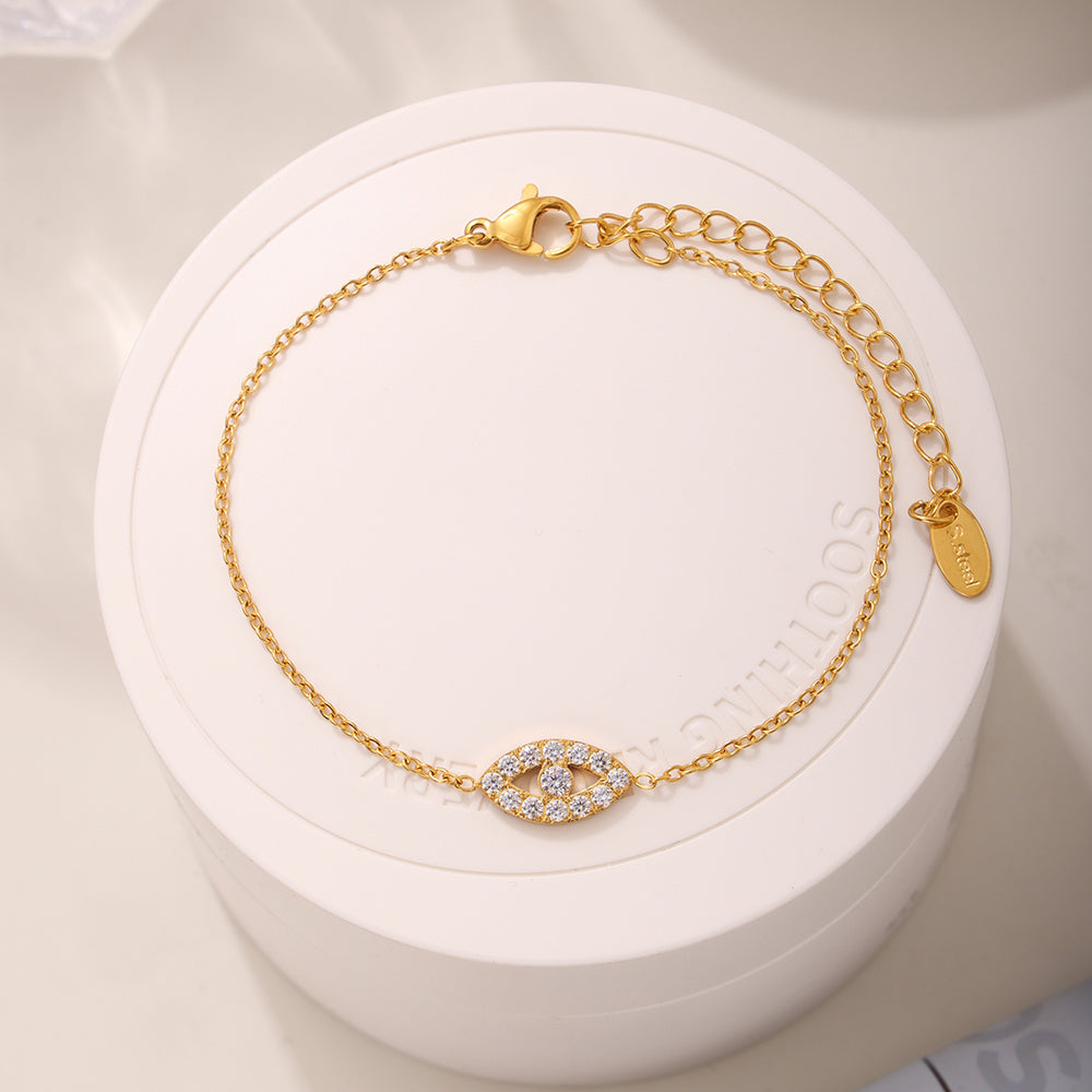 Mystic Evil Eye Bracelet with 5A Zircon under warm lighting showing sparkling zircon stones and metal shine