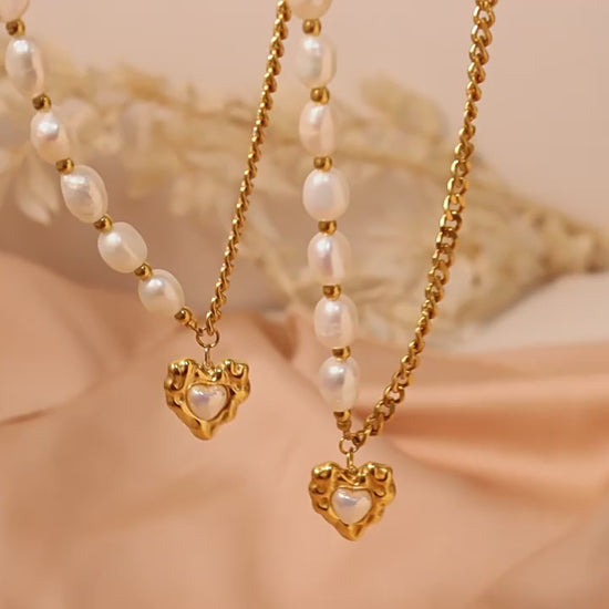 Watch the Luxe Radiance Heart Pendant Necklace in action—showcasing its high gloss pearl accent, stainless steel durability, and styling versatility for every occasion.