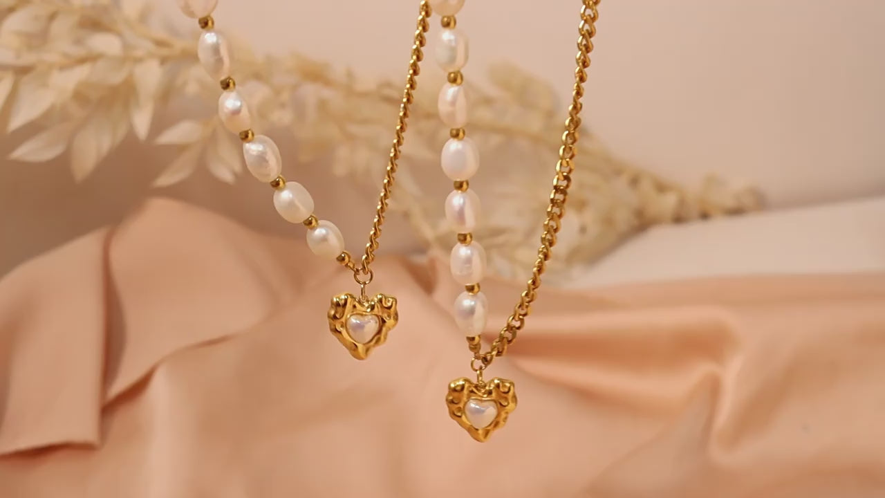 Watch the Luxe Radiance Heart Pendant Necklace in action—showcasing its high gloss pearl accent, stainless steel durability, and styling versatility for every occasion.